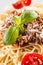 Close-up spaghetti bolognese with basil parmesan cheese and tomatoes