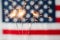 Close up of sparklers burning over american flag