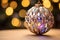 Close-Up of a Sparkling Holiday Ornament Capturing Reflections of Twinkling Lights