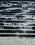 Close-up of sparkling water spashing down concrete stairs in a fountain into pool below  with water drops in the air