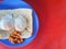 Close up a special breakfast of toast with half put eggs and red beans on red background