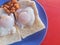 Close up a special breakfast of toast with half-put eggs and red beans on red background