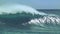 CLOSE UP: Spectacular hollow ocean wave splashes wildly towards the exotic coast