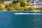 Close up speedboat on the Marina and Hillside houses in Queenstown Otago New Zealand rising from the shore of Lake Wakatipu