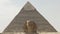 Close up of the sphinx with the pyramid of khafre in the background at giza