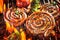 Close up on spicy coils of sausage grilling on BBQ