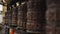 A close-up of a spinning buddhist prayer wheel in a row of wheels in Nepal Kathmandu