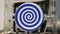 Close up of spinning mechanism creating hypnotic effect. HDR. White rotating circle with dark blue spiral, seamless loop