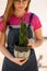 Close-up of spit of Sansevieria cylindrica shoots in pot in hands of woman