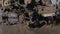 A close up of splashes of mud on a grouser of a tilling machine. Slow motion footage of a plougher equipment on a farm