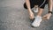 Close up at sport shoes of young  athlete woman is tying laces and getting ready to run