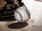 Close up sports background image of an old used weathered leather baseball laying in front of a ball glove on a wood butcher block
