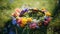 Close-up of spring summer flower wreath on a green meadow. Pagan tradition and holiday of Midsummer solstice