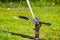 Close up of sprinkler spraying water on a field; lawn irrigation system