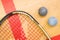 Close up of a squash racket and ball on the wooden background