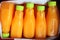 Close up Squeezed orange juice packed in clear plastic bottles