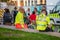 A close up of St John Ambulance staff waiting on a break with police and other people in the background