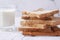 close up of stack of baked bread and glass of milk on table