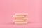 Close up of stack of beige make up sponges on pink background with copy space