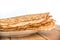 Close up on a stack of crepes french pancakes on a plate, white background