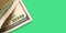 Close Up of Stack of dollars on green background