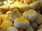 Close up stack of fresh baked short round bread, yellow warm tone, ready to sell Bakery pastry shop