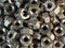 Close - up stack of metal nuts. Production and repair.