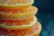 A close up of a stack of oranges with water droplets on them, AI