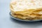 Close up stack of pita, Arabic bread, flatbread on gray wooden background. Soft focus. Traditional arabian food