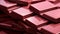 A close-up of a stack of Ruby Chocolate bars, each one detailed in