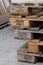 Close-up stack of shipping pallets with Velux inscription lying on the cement floor, selective focus