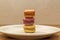 Close up stack of three macaron cookies on plate