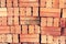 Close up of stacked clay bricks - constructional material - industrial production of bricks