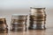 close up of stacks of coins on wooden tabletop