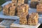 Close-up stacks of red brick neatly piled on concrete foundation of basement or first floor of future house for walls construction