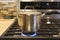Close-up of stainless steel cooking pot on gas stove in contemporary upscale home kitchen