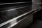 close-up of stainless steel countertop with black granite top and seamless transition