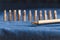 Close-up of stainless steel screwdrivers and various screwdriver heads placed on a blue denim