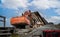 Close up of a standard or crawler excavator knocking down a house in Nuuk, Greenland