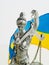 Close-up - a statue of the goddess of justice - Themis against the background of the Ukrainian flag. The rule of law, the trial of