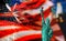 CLOSE UP OF STATUE OF LIBERTY WITH BLUR AMERICAN FLAG