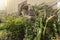 Close-up on a statue of a Moai head surrounded by tropical flowers at the west exit of Shibuya Station in Tokyo, Japan.