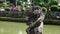 Close up of a statue and moat at pura taman ayun temple on bali