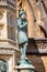 Close up  of statue of Sir Francis Drake on the Digby Memorial Cross in front of Sherborne Abbey in Sherborne, Dorset, UK