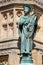 Close up  of statue of St Aldhelm on the Digby Memorial Cross in front of Sherborne Abbey in Sherborne, Dorset, UK