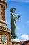 Close up  of statue of St Aldhelm on the Digby Memorial Cross in front of Sherborne Abbey in Sherborne, Dorset, UK