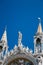 Close up of statues on the top of Basilica di San Marco, St Mark`s Basilica in Venice, Italy. Golden luxury detail of