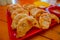 Close up of steamed Momo served in a red plate. A popular Nepalese food that is also common in Chiana, Bhutan, Tibet and