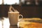 Close up of steaming cup of coffee or tea on vintage table