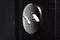 Close-up of steel key in lock of modern apartment house. Black background.